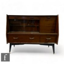 Unknown - A mid Century cabinet sideboard raised on splayed feet, the high back with an