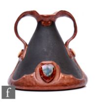 Bretby - An early 20th Century twin handled vase decorated in a matt and gloss bronze glaze with