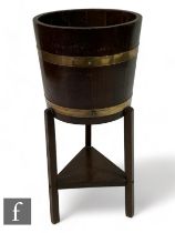 Lister Woodcraft - An Arts & Crafts coopered barrel form wooden jardiniere stand, raised on three