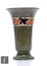 William Moorcroft - Banded fruit - A vase circa 1918, of footed sleeve form with everted rim,