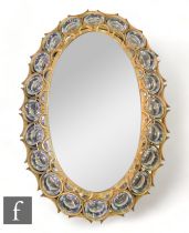 Bakalowits & Söhne - A 1960s illuminated wall mirror, the gilt metal oval back frame supporting