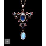 Attributed to Jessie M.King - Liberty & Co - An open work silver, enamel and moonstone pendant circa