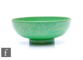 Ruskin Pottery - A small pottery bowl of footed circular form, decorated in an apple green glaze