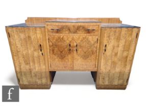 In the manner of Epstein - A 1930s sideboard, the panelled door front with drawer above, flanked
