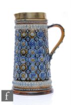 Doulton Lambeth - A large water jug of tapered cylindrical form, heavily decorated with repeat