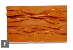 Brian Wilshere (1930-2010) - An abstract carved wooden wall panel of sectional wavy undulating form,