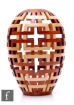 Bill Robinson - A contemporary open segmented woodturned vase of shouldered ovoid form, decorated