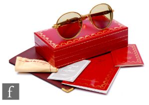 Cartier - A pair of full-rim Bagatelle series sunglasses circa 1993, 18K gold plated, Bubinga wooden