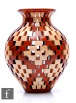 Bill Robinson - A contemporary open segmented woodturned vase of ovoid form with everted flared rim,