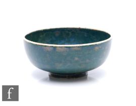 Ruskin Pottery - A miniature 1930s pottery bowl of footed circular form, decorated with a tonal blue