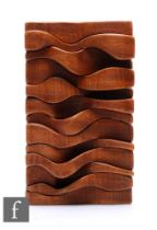 Brian Wilshere (1930-2010) - An abstract carved dark wood wall panel, of close packed sectional wavy