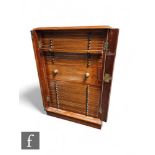 An Edwardian mahogany coin cabinet, fitted with thirty drawers, centred by a deep drawer, turned