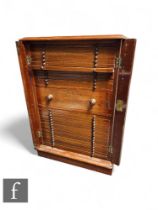 An Edwardian mahogany coin cabinet, fitted with thirty drawers, centred by a deep drawer, turned