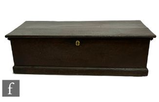 A George III oak deed box, the hinged top over a plinth base, width 85cm.