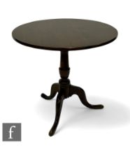 A George III mahogany circular oak tripod occasional table, turned pedestal and splayed tripod legs,