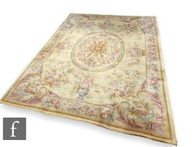 A 20th Century Aubusson style carpet, centred with a medallion of flowers surrounded by baskets of