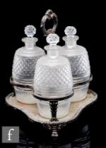 A 19th Century silver plated decanter stand with central carry handle fitted with three clear