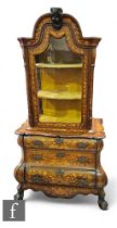 An 18th Century Dutch bombe marquetry display cabinet, the arched top enclosed by a glazed door
