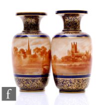 A pair of early 20th Century Doulton Burslem vases, each of footed cylindrical shouldered form