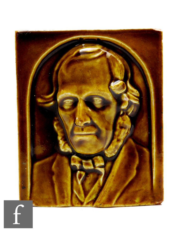 A 19th Century plastic clay portrait tile of a gentleman within an arch picked out in a toffee