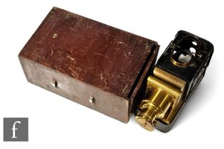 A 19th Century brass magic lantern in wooden case.