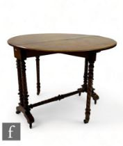 A Victorian figured walnut oval drop flap Sutherland dining table on ring turned supports united