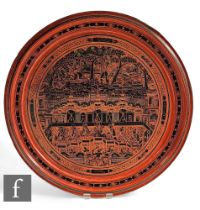 A 20th Century Indian cinnabar lacquered circular serving tray decorated with figures and detailed