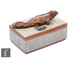 A 20th Century glazed stoneware rectangular box, the cover mounted with an iguana, width 16cm.