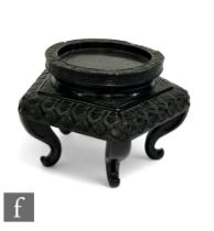 A 19th Century Chinese ebonised octagonal jardinière stand, floral border decoration on scroll feet,