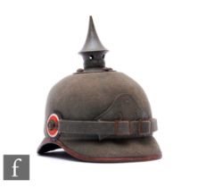 A World War One 22nd R.Regiment Ersatz Felt Pickelhaube, the grey painted steel fixed spike with