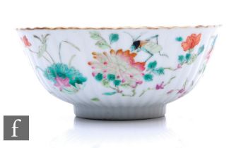 A Chinese Daoguang period (1820-50) famille rose bowl, of fluted form, the white glaze decorated