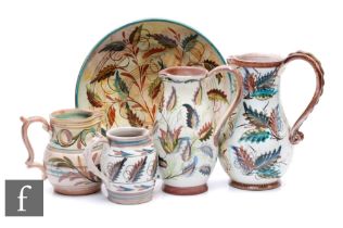 A large shallow Denby bowl decorated by Glyn Colledge with stylised flower heads and foliage,