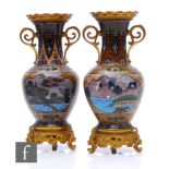 A pair of Chinese cloisonne vases of ovoid form, rising to a flared neck, decorated with ochre,
