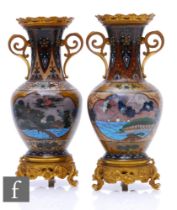 A pair of Chinese cloisonne vases of ovoid form, rising to a flared neck, decorated with ochre,