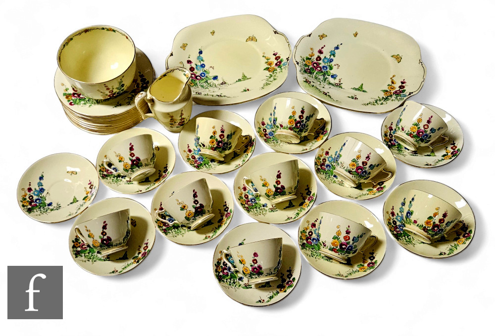 A 1930s Crown Staffordshire part tea service comprising ten cups, saucers and plates, two bread