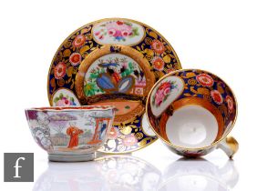 A 19th Century English porcelain tea cup and saucer decorated with panels of flowers against a