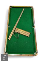 A 1930s quarter or child's size table top snooker table with cue, balls, score board and