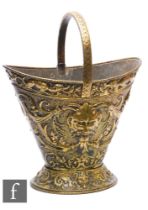 A 20th Century or earlier Renaissance style brass coal bucket with fixed handle, grotesque masks