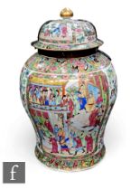 A Chinese late 19th Century Canton famille rose vase of baluster form, the body decorated with