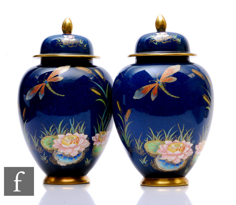 A pair of late 1930s Carlton Ware ginger jars and covers, each of footed ovoid form with domed