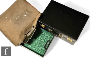 An early 20th Century green leather suitcase by Finnigans, Bond Street, London, with brass