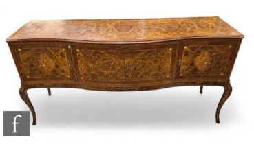 A 20th Century Italian figured walnut dining room suite, comprising a serpentine front sideboard