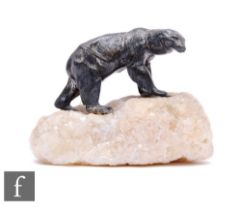 A small 20th Century bronzed Polar Bear standing on a white piece of quartz modelled as an