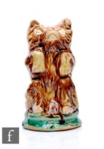 A 19th Century ceramic pounce pot in the form of a seated bear with pour holes to the top of the