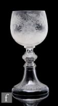 A large late 19th Century continental goblet, the ovoid form bowl profusely engraved with flowers