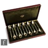 A cased set of continental silver coffee spoons, bright cut decoration to bowls in a plush lined