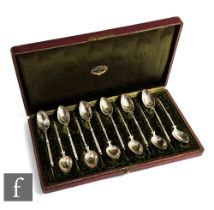 A cased set of continental silver coffee spoons, bright cut decoration to bowls in a plush lined