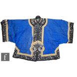 A Chinese late Qing Dynasty embroidered silk short jacket, the blue ground, edged with embroidered