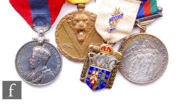 A Belgium Victory Medal, an Imperial Service Medal, a Canadian Voluntary Medal and a silver