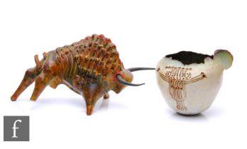 A mid 20th Century studio pottery figure of an abstract bull with heavily textured decoration,